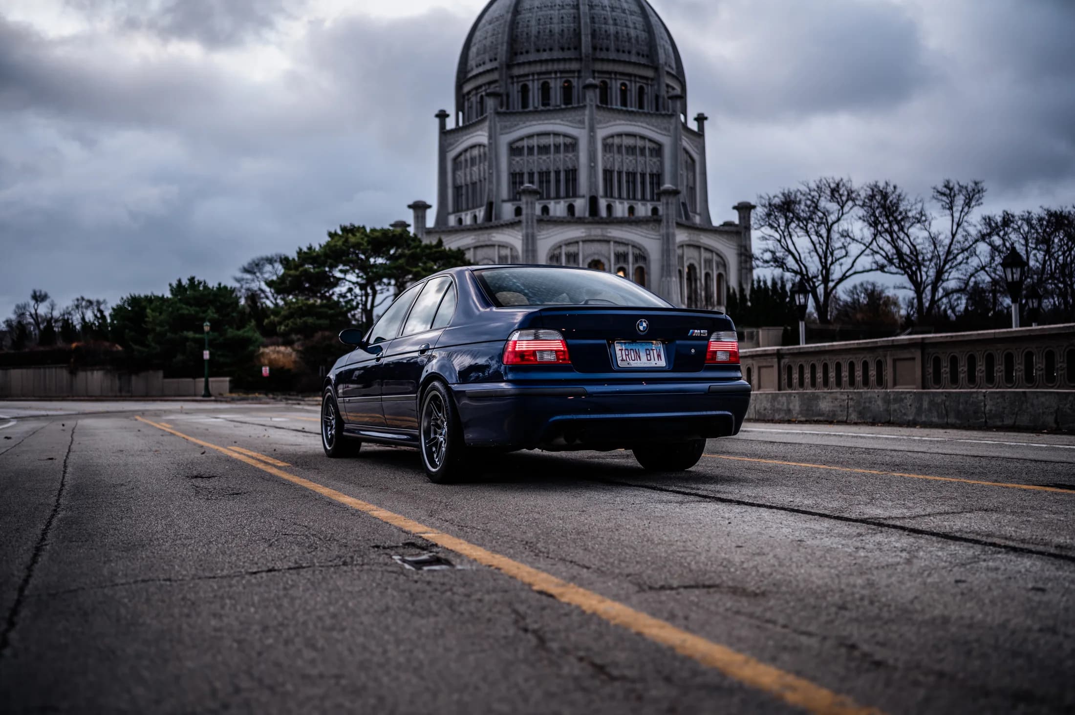 Blue BMW E39 M5 outside historic architecture